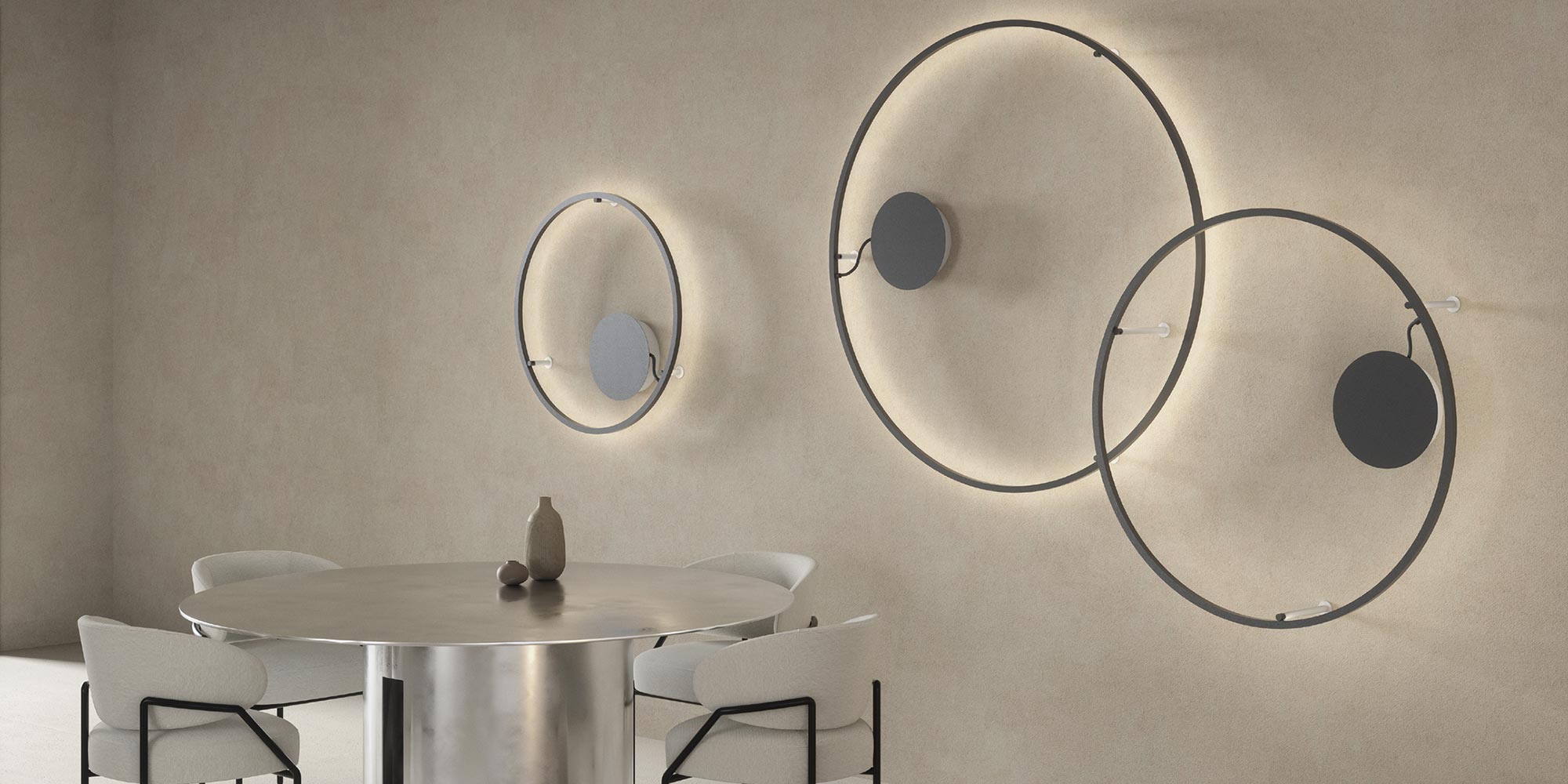 Rings refers to an illumination system with a circular-shaped light fixture or light arrangement. Architects and designers increasingly turn to ring-shaped luminaires for their versatility. Their beauty lies in their ability to combine form and function seamlessly. This month, we are excited to present a selection of options from our manufacturers that will meet your needs.